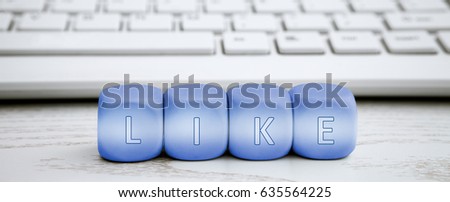 Letter dice with like text and white keyboard in the background
