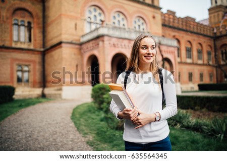 A portrait of a mixed race college student at campus Royalty-Free Stock Photo #635564345