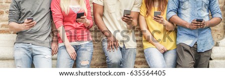 Diverse culture students watching smart mobile phones in university break - Young people addiction to new technology trends - Alienation moment for new generation problem  Royalty-Free Stock Photo #635564405