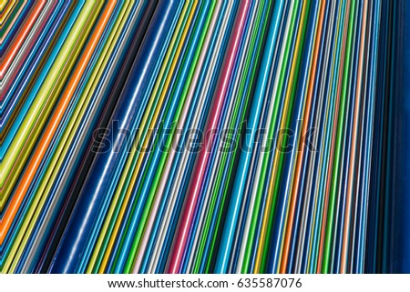 Multicolored pipes. Color Geometry. Colorful texture of vertical bars or planks made of  plastic. Rainbow of colors and geometry of lines brings to memory bar code. Texture or background