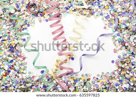 Background of confetti and serpentine. Copyspace. Carnival, party, celebration.