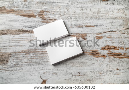 Two piles of blank business cards on vintage wood table background. Mockup for ID. Blank template for branding identity.