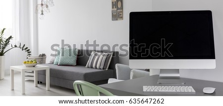 Light flat in new style with sofa, simple desk and computer, panorama