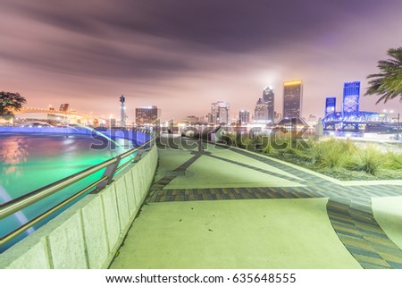 Night skyline of Jacksonville with buildings and square fountain, Florida.