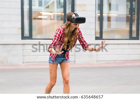 beautiful young girl with virtual reality VR headset on the street