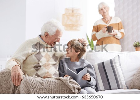 Happy grandfather spending male evening with his grandson Royalty-Free Stock Photo #635650670