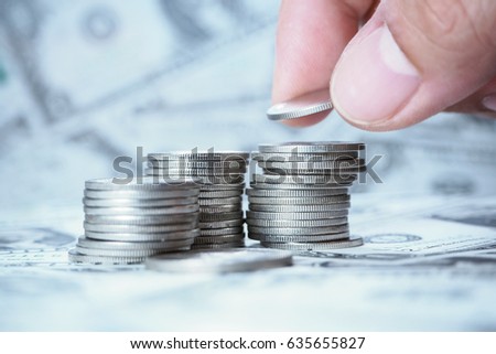 Hand Sort coins with Dollar bank Background 