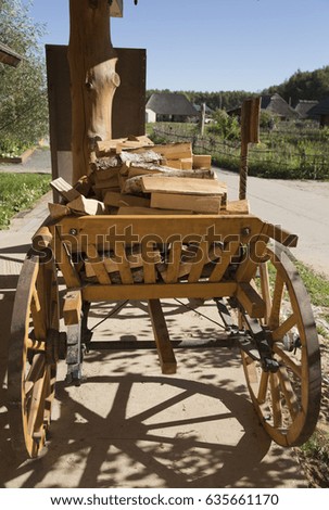 The wooden cart with  firewood.