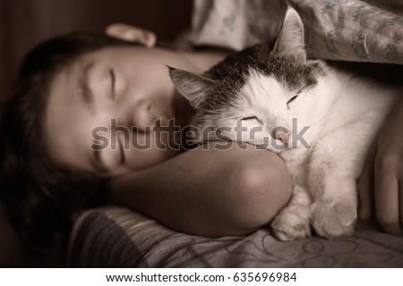 teen boy sleep with cat in bed hug close up photo