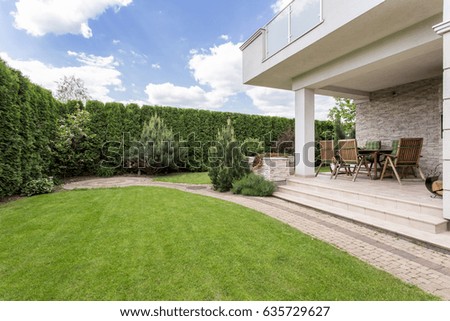 Modern house with beauty garden and terrace Royalty-Free Stock Photo #635729627
