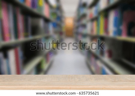 interior of modern library with gray book shelves, blur background with selective focus wood table for display your product