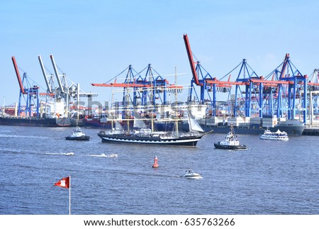 Hamburg harbor, birthday parade with various ships. View to Hamburg harbor with harbor cranes.