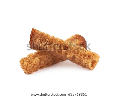 Pile of seasoned bread croutons sticks isolated over the white background