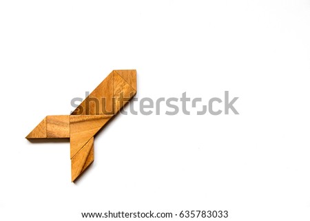 Wooden tangram puzzle in rocket shape on white background (Concept for new experience, start project)