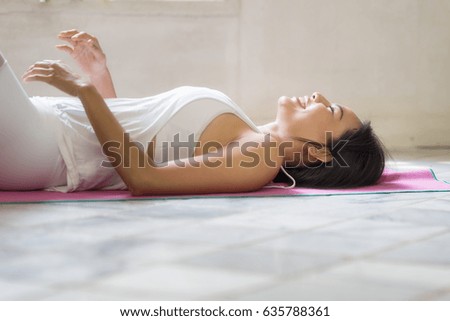 Charming and meditates while practicing yoga by the window. Freedom  fitness woman doing exercises at home Concept of healthy lifestyle.Calmness and relax  woman.
