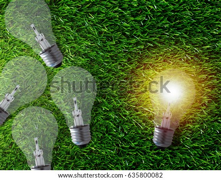 Think different concept, group of light bulb on green grass background