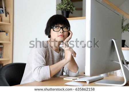 The Asian woman working with computer.