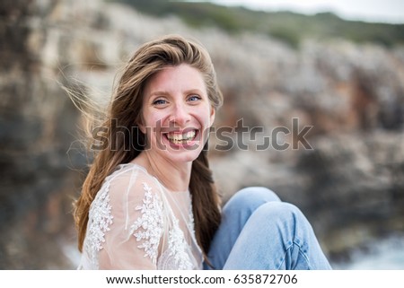 Portrait of laughing woman. Seaside