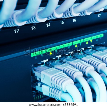 closeup of network hub and cables blue toned Royalty-Free Stock Photo #63589591
