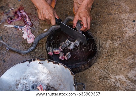 moving shot slice cooking exotic menu with snake on hardwood plate outdoor kitchen