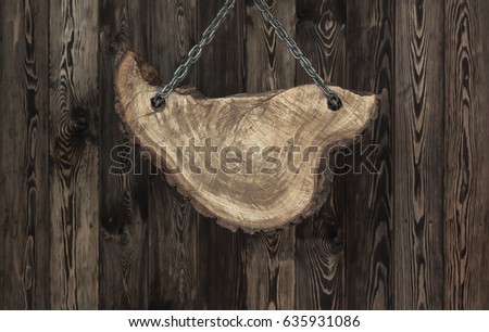Suspended wooden frame on the background of a wooden wall