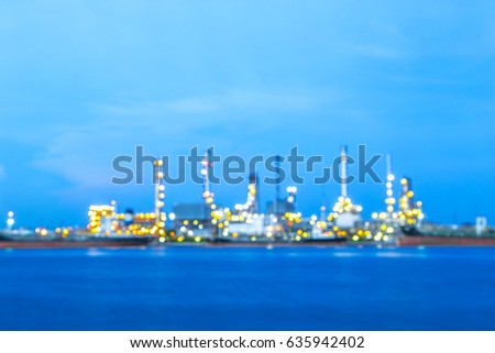 Blurred Photo bokeh of  Industrial view at oil refinery plant form industry zone with evening sunset or sunrise sky at the Chaophaya river in Bangkok Thailand