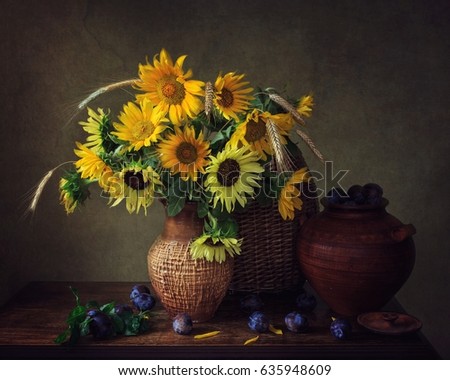 Still life with sunflowers and plums