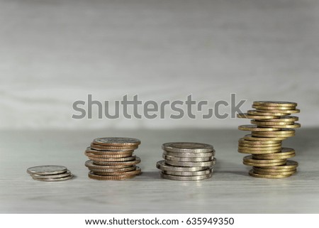 The money of stack coin tower on wood background