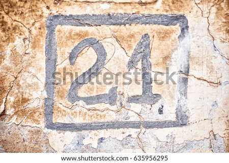 The two and one numerals in square are drawn on cracked wall. 