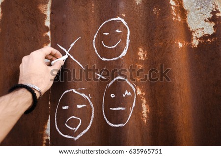 male hand writing with chalk at a rusty plate or wall