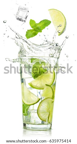 lime and mint falling into a cocktail splashing  Royalty-Free Stock Photo #635975414