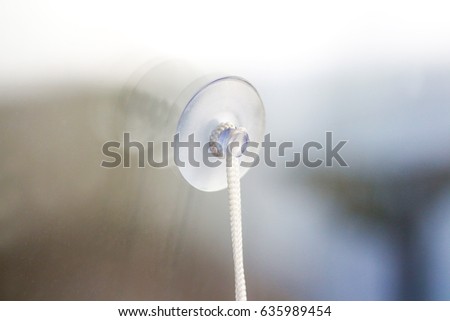 Transparent plastic suction Cup glued to the window Royalty-Free Stock Photo #635989454