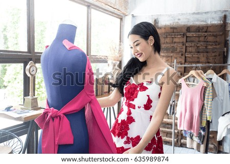 Elegant Asian Woman in Fashion Store - Stylish woman in fashion boutique among trendy gowns, 20s age.