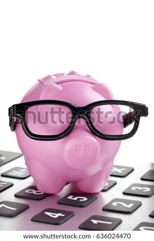 Pink piggy bank on calculator savings business concept