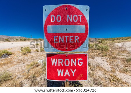 Bright Red sign warns drivers not to enter this lane of highway, Interstate 15, in desert outside of Las Vegas - WARNING - WRONG WAY!, Nevada