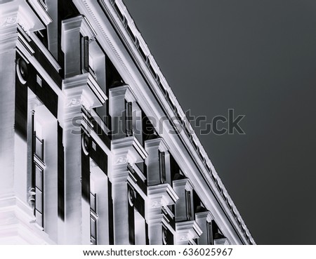 Parisian building facade in black and white at night pollution city view center of Paris, France