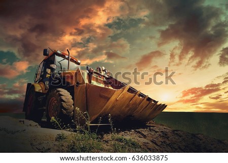 Yellow tractor on sky background Royalty-Free Stock Photo #636033875