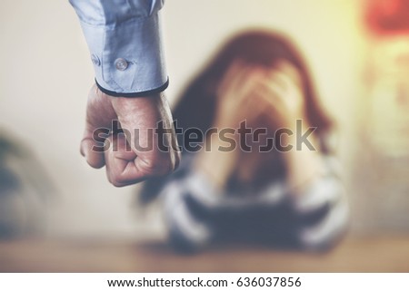 Man beating up his wife illustrating domestic violence Royalty-Free Stock Photo #636037856