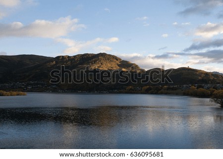 View over Queenstown in the morning with mountains in background and Lake Wakatipu in foreground.