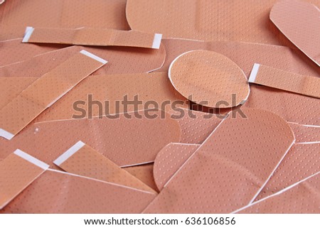 Adhesive plaster for skin injury or other concept.