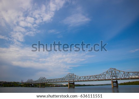 Steel Bridge Across a River Under Blue Skies
