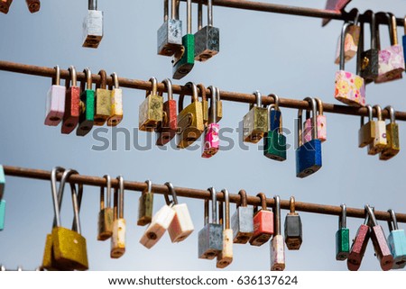 Love locks hang from a bridge