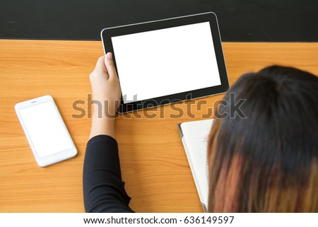 Teenage freelance working business on tablet. The blank screen with copy space for your text or advertising content. Selective focus. Clipping path in picture.