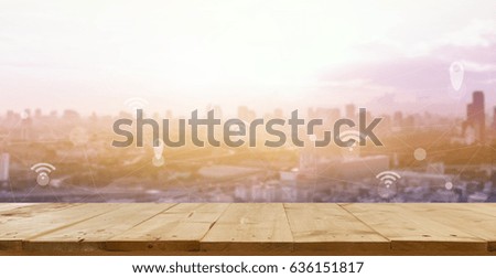 Internet connect concept. wooden floor with blur city business connection background.