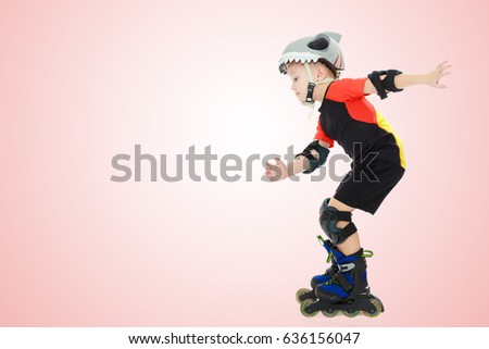 Sports little boy riding on roller skates helmet and knee pads. Side view.Pale pink gradient background.