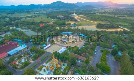 sunset at Huay Mongkol temple.the black Buddha statue name Luang Phor Tuad is the one buddhist amulets famous in Thailand