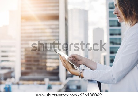 Closeup image of female manager using digital tablet outdoors with the background of the city, Woman  checking information via digital tablet
