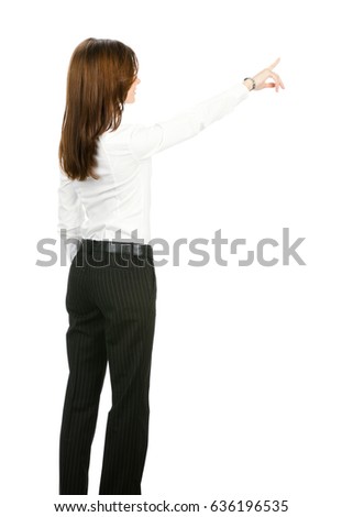 Full body of young businesswoman pointing at something in her back, isolated on white background. Success in business concept studio shoot.