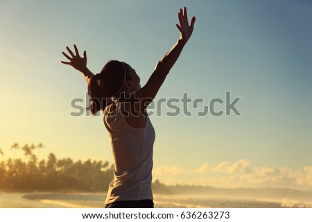 healthy lifestyle young woman open arms on sunrise seaside beach