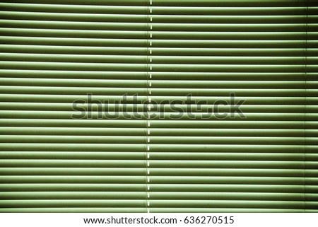 Plastic blinds on the window with lighting.